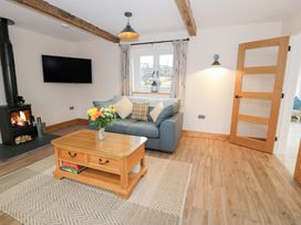 A living room with a sofa and coffee table at Merddwr Cerrigydrudion