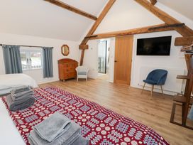 A bedroom with a bed and furniture at Merddwr in Cerrigydrudion