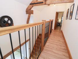 A hallway with staircase and pictures at Merddwr in Cerrigydrudion