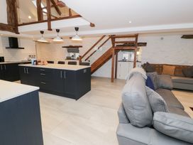 A kitchen with a kitchen island and sofa at Merddwr in Cerrigydrudion