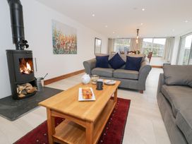 A living room with a fireplace and a coffee table at Merddwr in Cerrigydrudion