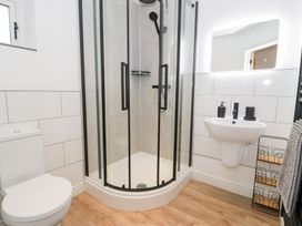 A bathroom with a shower, toilet, and sink at Merddwr in Cerrigydrudion