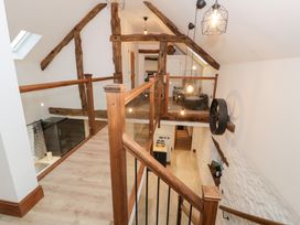 A landing with wooden staircase and light fixtures at Merddwr in Cerrigydrudion