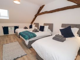 A bedroom with three beds at Merddwr in Cerrigydrudion