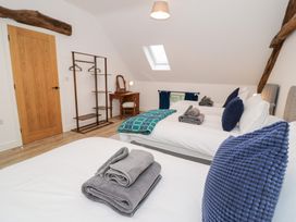 A bedroom with beds and a desk at Merddwr in Cerrigydrudion