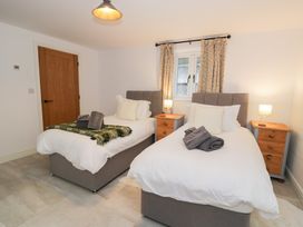 A bedroom with two single beds and bedside tables at Merddwr in Cerrigydrudion