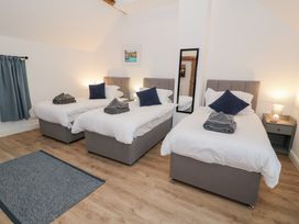 A bedroom with three single beds at Merddwr in Cerrigydrudion