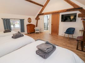 A bedroom with two beds and a dresser at Merddwr in Cerrigydrudion
