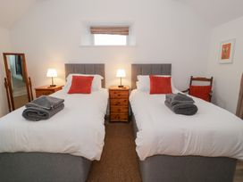 A bedroom with two single beds and nightstands at Merddwr in Cerrigydrudion