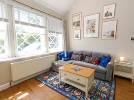 A living room with a sofa and coffee table at Sea Pink Cottage in Langton Matravers