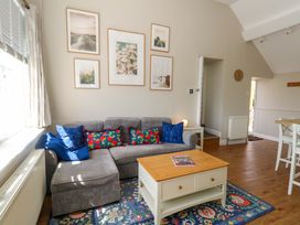 A living room with a sofa and coffee table at Sea Pink Cottage in Langton Matravers