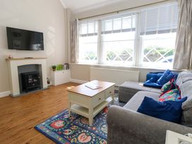A living room with a sofa and coffee table at Sea Pink Cottage in Langton Matravers