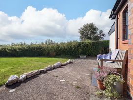 A garden with a bench and plants at Bethania Cefn Coch near Llanrhaeadr-Ym-Mochnant