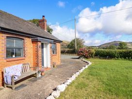An outdoor area with a bench and flowers at Bethania Cefn Coch near Llanrhaeadr-Ym-Mochnant