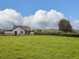 A house with a fence in a field at Bethania Cefn Coch near Llanrhaeadr-Ym-Mochnant