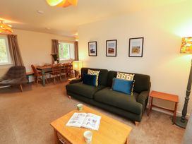 A living room with sofa and dining area at Swallow's Nest Thornthwaite near Braithwaite