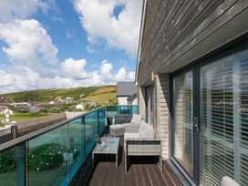 A balcony with outdoor furniture at Sandbanks in Praa Sands