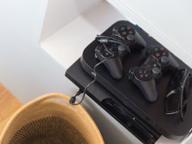 A gaming console with controllers and sunglasses at Sandbanks in Praa Sands
