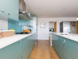 A kitchen with cabinets and appliances at Sandbanks in Praa Sands