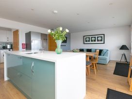 A kitchen with a dining area and living space at Sandbanks in Praa Sands