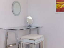 A dressing room with a vanity table and mirror at Sandbanks in Praa Sands