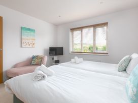 A bedroom with two single beds and a TV at Sandbanks in Praa Sands