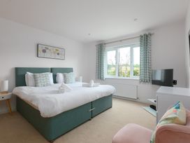 A bedroom with a bed and tv at Sandbanks in Praa Sands