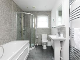 A bathroom with shower, bathtub, sink and toilet at Sandbanks in Praa Sands