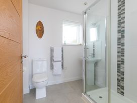 A bathroom with a shower and toilet at Sandbanks in Praa Sands