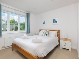 A bedroom with a bed and window at Sandbanks in Praa Sands