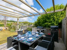 An outdoor dining area with a table and chairs at Sandbanks in Praa Sands