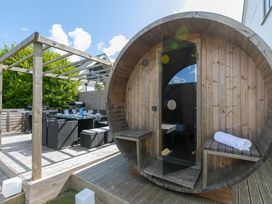 An outdoor area with a sauna and dining setup at Sandbanks in Praa Sands