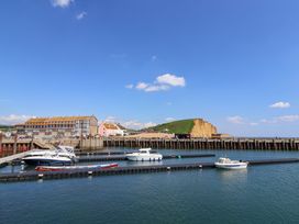 A harbor view with boats and buildings at West Bay Holiday Home in West Bay