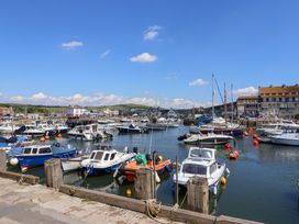 A view of a harbor with boats and buildings at West Bay Holiday Home in West Bay
