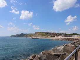 A coastal view with cliffs and a beach at West Bay Holiday Home in West Bay