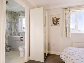 A bathroom with a toilet and sink at West Bay Holiday Home in West Bay