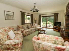 A living room with floral furniture and a television at Kala Spittal near Haverfordwest