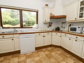 A kitchen with cabinets and appliances at Kala in Spittal near Haverfordwest