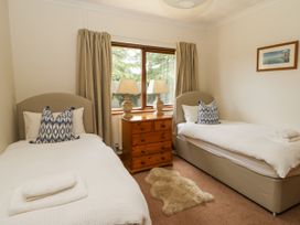 A bedroom with two beds and a dresser at Kala in Spittal near Haverfordwest