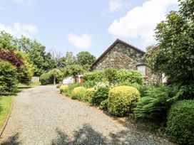 A stone house with a gravel drive and garden at Kala in Spittal near Haverfordwest