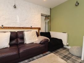 A living room with a sofa and cushions at Tyddyn Elidir near Old Colwyn