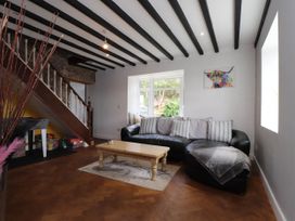 A living room with a sofa and coffee table at Tyddyn Elidir near Old Colwyn