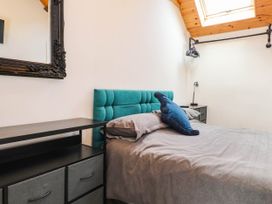 A bedroom with a bed and nightstand at Tyddyn Elidir near Old Colwyn