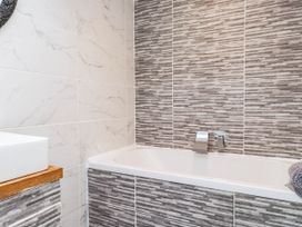 A bathroom with a bathtub and sink at Tyddyn Elidir near Old Colwyn
