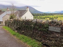 An outdoor view of North Row Cottages and stone wall in Bassenthwaite