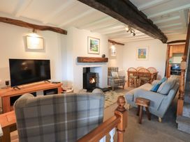 A living room with furniture and a fireplace at Squirrel Cottage in Bassenthwaite