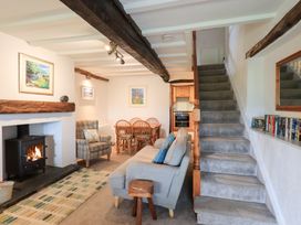 A living room with a sofa and dining table at Squirrel Cottage in Bassenthwaite