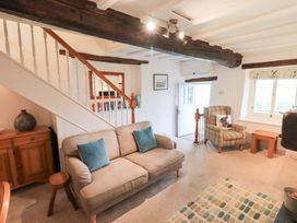 A living room with a sofa and armchair at Squirrel Cottage in Bassenthwaite