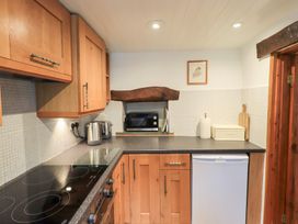 A kitchen with a microwave and kettle at Squirrel Cottage in Bassenthwaite