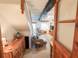 A living room with a couch and television at Squirrel Cottage in Bassenthwaite